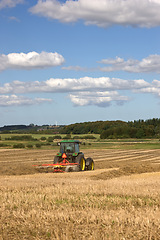 Image showing Field, grass and tractor for farming rice, agriculture and sustainability in countryside or environment. Farmer plough for wheat, plants and harvesting on land for production, supply chain and nature