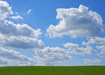 Image showing Blue sky, clouds and landscape at countryside with environment, sustainability and summer sunshine. Nature, beauty and field with grass for eco friendly, growth and horizon with lawn on earth