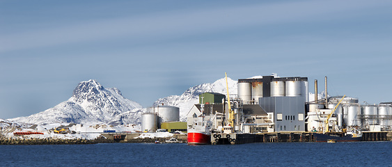 Image showing Fishing, plant and industrial tank on water for processing, production and feed mill for fish industry in Norway. Manufacturing, containers and warehouse for agriculture and sea factory with blue sky