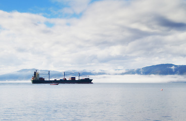 Image showing Ship, journey and sailing at sea with cargo for transportation, international trade and logistics industry in morning. Export, vessel and freight in ocean for travel, shipping business or merchandise