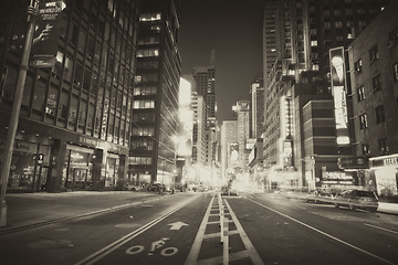 Image showing New York, city and downtown street or night adventure with buildings or black and white, dark or holiday. Road, urban and lights with cars or explore weekend or late outdoor vacation, evening or trip