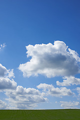 Image showing Blue sky, clouds and nature at countryside with environment, sustainability and mockup in summer. Beauty, nature and zen field with grass for growth, eco friendly and horizon with lawn on earth