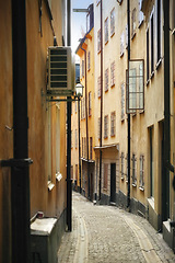 Image showing Travel, architecture and alley in vintage city with history, culture or holiday destination in Sweden. Vacation, old buildings and antique stone street in Stockholm with cobble path in ancient town