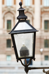 Image showing Travel, architecture and lamp on vintage wall in old town with history, culture or holiday destination in Sweden. Vacation, landmark and antique lantern in Stockholm with retro light ancient city