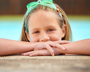 Image showing Girl, relax and portrait of kid in swimming pool with goggles for games outdoor on holiday or vacation. Calm, child and rest on hands, balance on side and happy in water at resort or house in summer