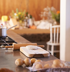 Image showing Dough, pin and wooden board in kitchen with ingredients on counter for baking and cooking with pastry for bread with recipe. Flour, wheat and potatoes with stove and pot for food with vegetables