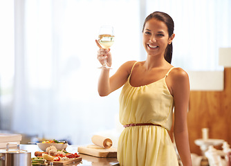 Image showing Woman, happy and smile with wine glass while cooking, vegetables and cheers for celebration in kitchen. Female person, food and alcohol while preparing dinner, meal for nutrition at home or house