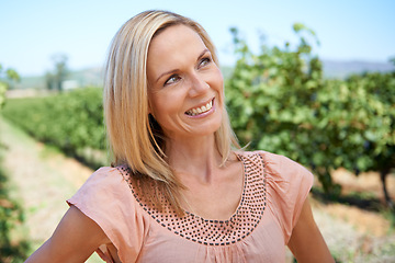 Image showing Mature, woman and vineyard with smile, thinking and nature for relaxation and sunshine. Person, summer and farm for rest, break and happiness with sustainable agriculture and holiday or vacation