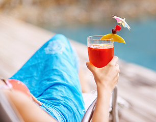 Image showing Closeup, hand and cocktail on summer vacation for fun, relax and drink at hotel pool in Bangkok. Woman, swimwear and alcoholic beverage to toast for me time at peaceful, luxury and holiday resort