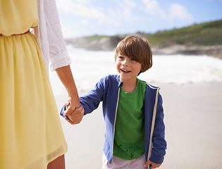 Image showing Walking, kid and mother on the beach holding hands in summer, holiday or vacation with happiness in Florida. Happy, child and mom relax on sand together at ocean or sea for adventure in Miami