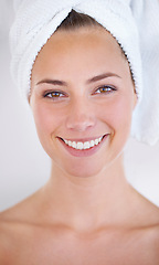 Image showing Woman, face and smile with towel for skincare, dermatology, and cosmetic treatment for beauty. Model, happy person and clear skin for hygiene and cleanse for natural and fresh with bright smile