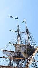 Image showing Sailing, ship and mast outdoor with flag for travel, journey and adventure by blue sky in summer. Boat, wood pole and vintage schooner vessel on a cruise, rigging and transport with rope on mockup