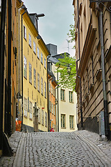 Image showing Travel, architecture and road in vintage alley with history, culture or holiday destination in Sweden. Vacation, old buildings and antique stone street in Stockholm with cobble path in ancient city