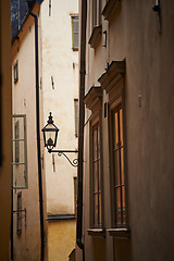 Image showing Travel, alley and lantern on vintage building in old town with history, culture or holiday destination in Sweden. Vacation, architecture and antique lamp in Stockholm with retro light in ancient city