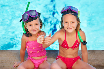 Image showing Portrait, girls and happy children with thumbs up at swimming pool, sisters or siblings outdoor together to relax in summer. Smile, kids and like by water for vacation, holiday and family in swimsuit