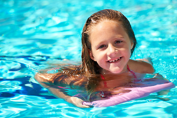 Image showing Happy, portrait and child with inflatable in swimming pool, games or learning with support in water park on vacation. Holiday, activity or girl relax at resort with toys to enjoy adventure in summer