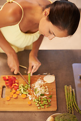 Image showing Cooking, food and health with chef in kitchen of home to prepare meal for diet or nutrition from above. Woman, nutritionist or vegan and person cutting green vegetables with knife in apartment