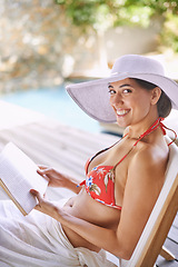 Image showing Woman, bikini and smile for portrait, book and hat at resort in Dubai by swimming pool. Female person, holiday and happy in summer, beauty and outdoor for wellness and relaxation in travel trip