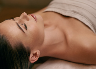 Image showing Woman, lying and calm in spa for wellness or peace, massage therapy or skincare and relax to free tension. Female person, resort and luxury for stress relief or rest for wellbeing with mindfulness.