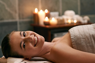 Image showing Happy, woman and portrait in spa with candles at night for luxury treatment in hotel on vacation. Girl, relax and smile for cosmetics, skincare and holiday at resort to care for beauty and wellness