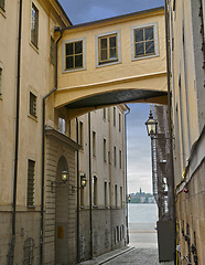 Image showing Skybridge, architecture and city with vintage building in old town with history, culture and calm holiday destination. Vacation, travel or quiet alley in Sweden with retro aesthetic in ancient street