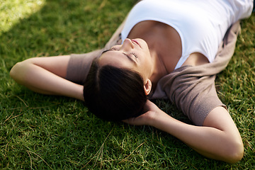 Image showing Relax, sleep and woman on grass of field, nature or park outdoor in summer for fresh air or free time. Environment, peace and wellness with calm young person lying on lawn in backyard to rest