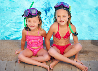 Image showing Kids, sitting and relax at swimming pool in summer, ready for adventure at resort on vacation. Holiday, games and friends thinking with goggles of fun, activity or children with safety gear for water