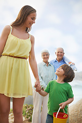 Image showing Family, mom and kid holding hands on beach for vacation, adventure and tropical holiday in Australia. Grandparents, mother and happy face of boy child at ocean with love, weekend and smile in summer.