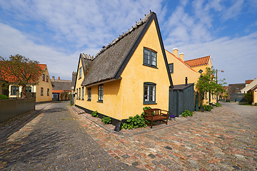 Image showing House, road in village or countryside landscape, travel and adventure location with cobblestone path and buildings. Neighborhood, real estate and property with architecture for holiday in Denmark