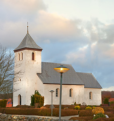 Image showing Cloud, tree or chapel in autumn for worship, faith and hope on Sunday evening service in Copenhagen. Sky, church and bushes for spiritual, trust and god for prayer, religion and silver lining