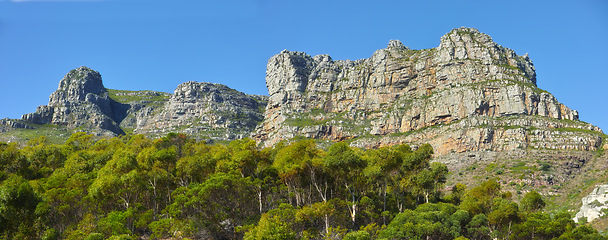 Image showing Mountains, environment and blue sky with nature, summer and stone with landscape and weekend break. Empty, rock and plants with flowers and countryside with spring and travel with vacation or holiday