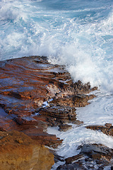 Image showing Beach, water and travel with freedom, vacation or summer holiday, seascape or adventure in nature. Ocean, rock or boulder in Portugal for tropical paradise, peace or relax with stress relief at sea