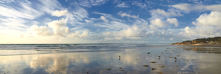 Image showing Blue sky, ocean and landscape of beach in California for tropical holiday, vacation and travel destination. Nature, island and sea, waves and water in summer for location, background and horizon