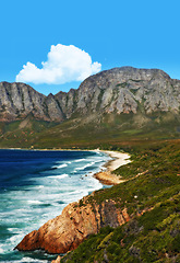 Image showing Mountain, ocean and landscape with nature, waves and surf with coastline and outdoor travel destination. Cliff, Earth and water with seascape view, natural background and beach location in Cape Town