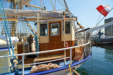 Image showing Boat, water and dock at sea to travel with closeup, windows and transportation for vacation sailing. Vessel, harbor and ocean with yacht for tourism, holiday and adventure with morning, sky or nature