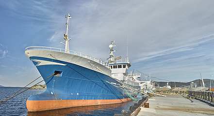 Image showing Ship, water and harbor at sea to travel with closeup, pier or transportation for vacation sailing in summer. Vessel, dock or ocean with yacht for tourism, holiday or adventure with blue sky in nature