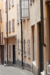 Image showing Travel, architecture and alley in vintage town with history, culture or holiday destination in Sweden. Vacation, old buildings and antique street in Stockholm with retro cobble road in ancient city