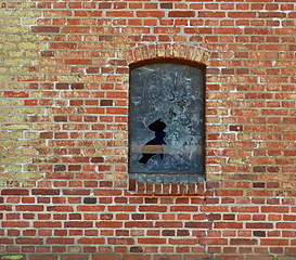 Image showing Old, broken window and exterior with brick wall of abandoned house, building or concrete frame. Historic outdoor texture of rubble, glass crack or damage from war, wreck or destruction in vandalism