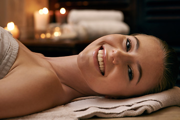 Image showing Happy, woman and portrait in spa with candles at night for luxury treatment in hotel on vacation. Girl, relax and smile on table for cosmetics, skincare and holiday at resort for beauty and wellness