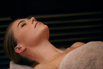 Image showing Woman, lying and relax in spa for wellness or peace, massage therapy or skincare and calm to free tension. Female person, resort and luxury for stress relief or rest for wellbeing with aromatherapy.