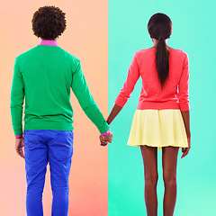 Image showing Couple, back and holding hands with fashion in studio, background and creative aesthetic. Together, woman and man with colorful style, unique clothes or people with support or trust in mockup space