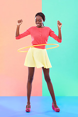 Image showing Woman, smile or hoop for fashion, casual or spring outfit for play or game on color block background. Female person, spinning or plastic toy for funky, colorful or stylish clothing for fun in studio