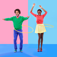 Image showing Couple of friends, smile and play for dance, hoop and hand up for joy on color block background. Excited, man and woman for bonding, spinning and plastic toy for funky, quirky and game in studio