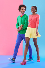 Image showing Couple, walk and happy with fashion in studio, background and creative aesthetic. Excited, woman and man together with colorful retro style, unique clothes or person with support, love and trust
