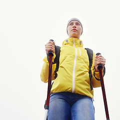 Image showing Woman, hiking and outdoor fitness in nature with gear for travel, adventure and sightseeing in white background. Explore, low angle and person in trekking pole for wellness, health or balance.