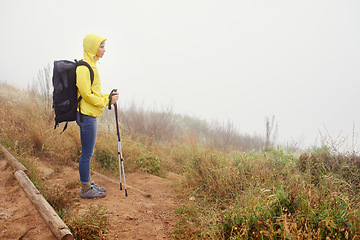 Image showing Hiking woman, fog and exercise for cardio, walking stick and activewear for fitness. Backpack, adventure or mountain trail with morning overcast, sport or female athlete in nature and resting