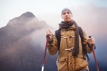 Image showing Woman, hiking and thinking in mountain with trekking sticks, winter and peace of exercise in nature. Athlete, adventure or sport gear for safety in outdoor environment, cold or walking for fitness