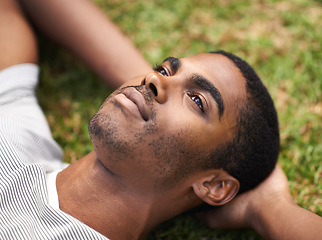 Image showing African man, thinking and relax on grass in nature, idea and vision on summer holiday plan. Thoughtful, enjoying fresh air or reflection, sunshine and peace for freedom after work week on vacation