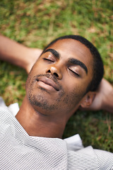 Image showing Black man, relax and laying on grass, nature and summer in garden for vacation mindfulness or stress free. Enjoy, dreaming of future holiday plans, sunshine after work week, calm and rest for freedom
