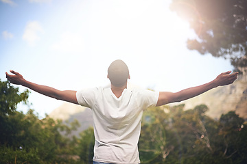 Image showing Man, freedom and arms stretched, happiness and appreciate nature in sunlight. Black male person, outdoors and lensflare on vacation for adventure or optimist, grateful and wellness or blue sky